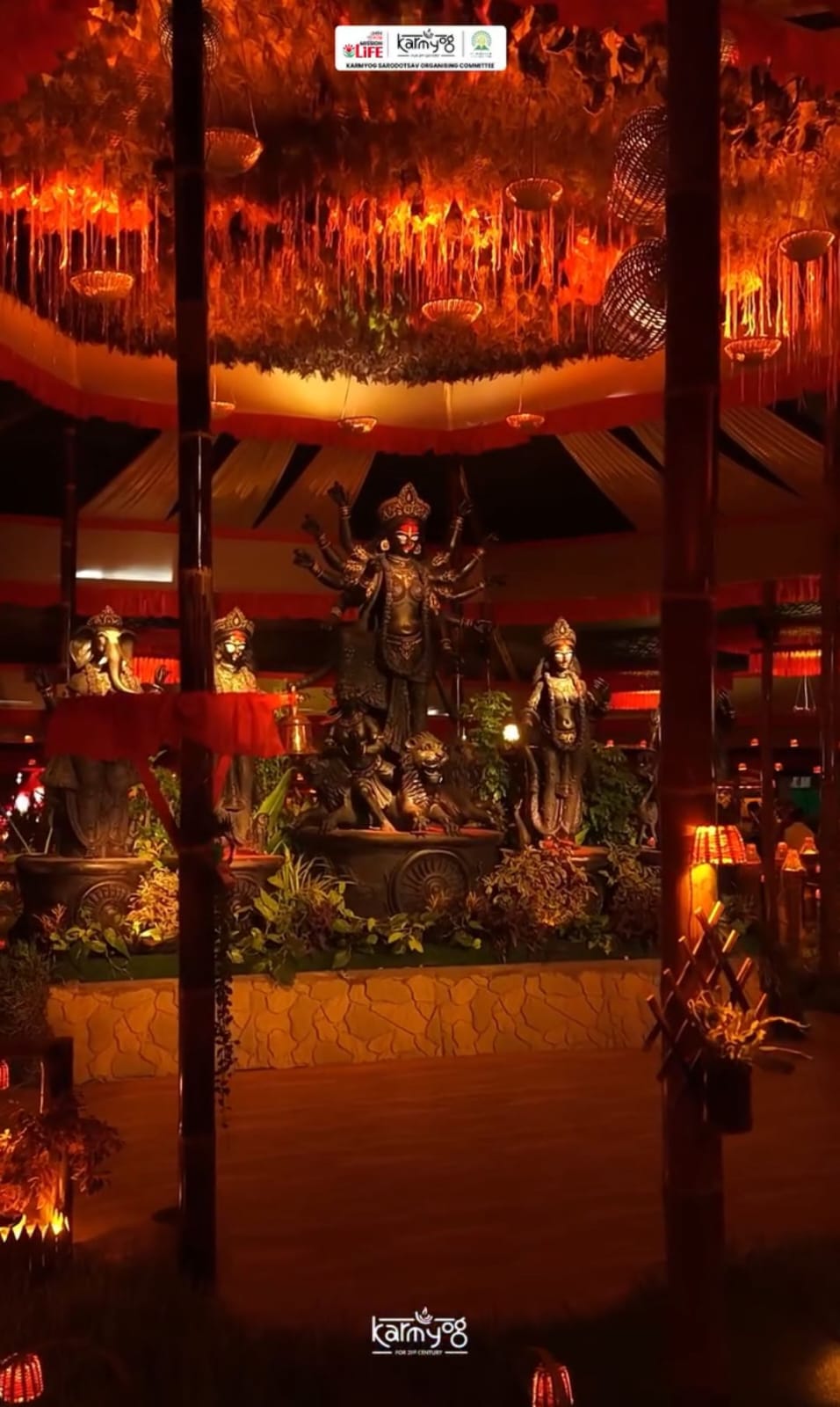 Close-up of Durga idol viewed through bamboo garlands