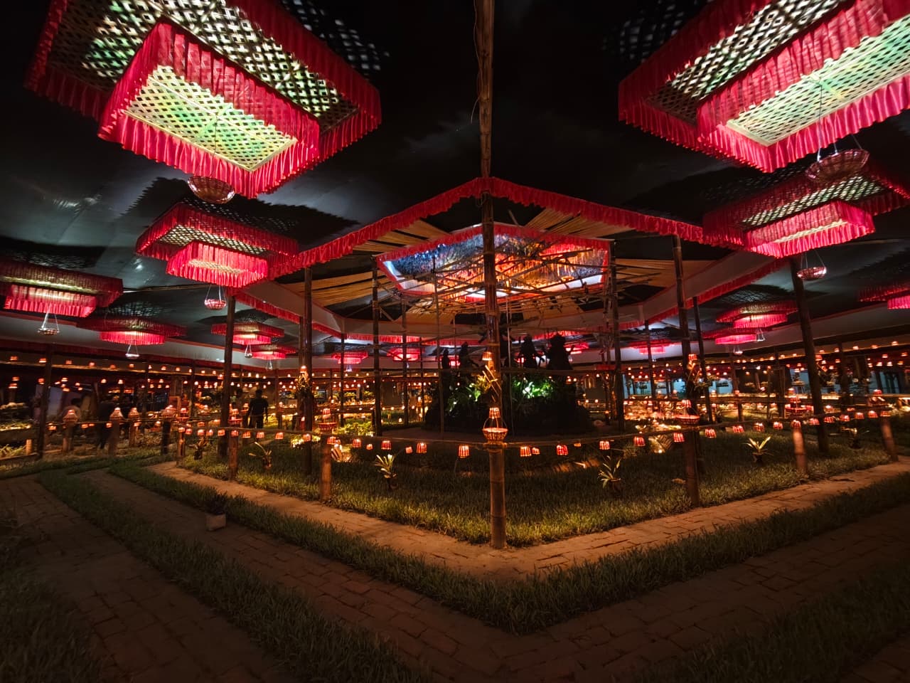 Interior garden courtyard at night with red woven chandeliers