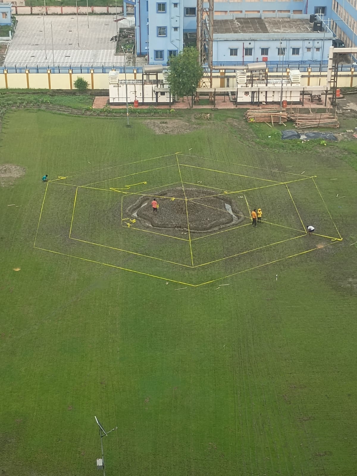 Aerial view of the bare field with foundation strings marking the layout